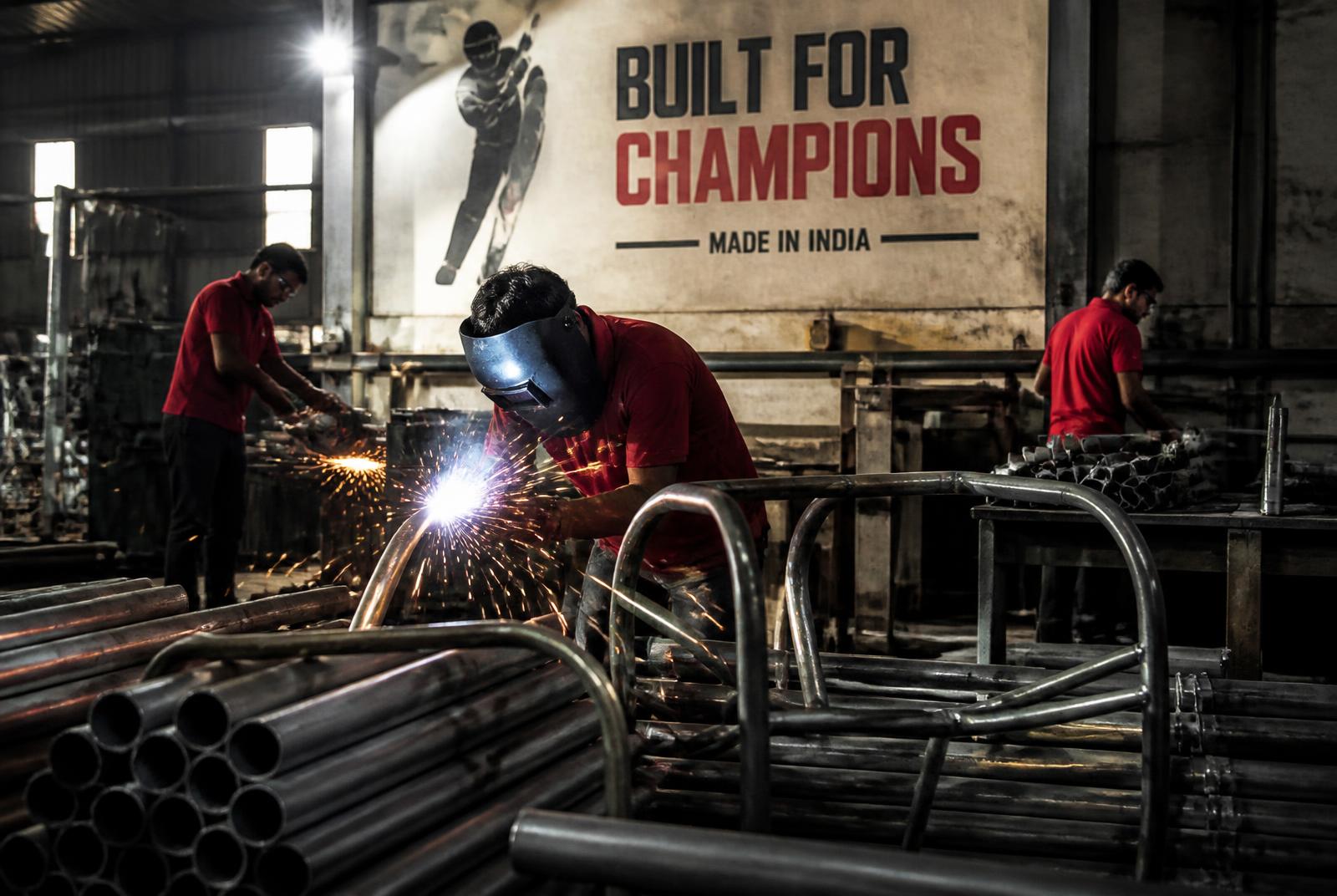 Welder fabricating steel frames on the ACHIEVER shop floor